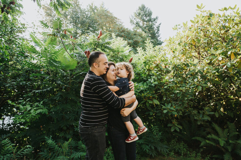 Big family hug in a Portland backyard during a photography session.