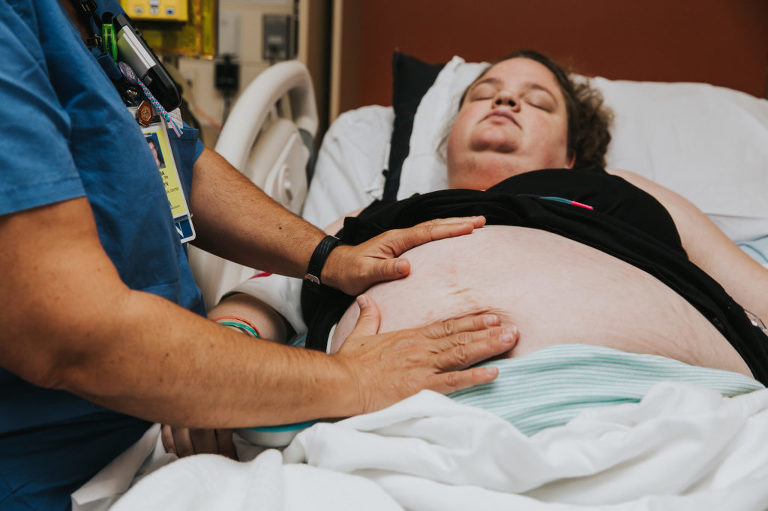 L+D nurses checks mom and belly during labor at Kaiser Westside in Hillsboro, Oregon.