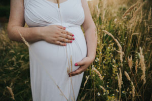 Close up of mom's hands on her pregnancy bump during a maternity session in Hillsboro, Oregon